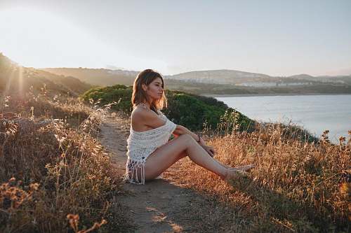 apparel woman sitting near river clothing