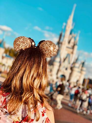 person woman wearing golden Mickey Ears at Disneyland hair