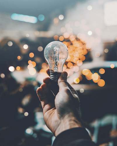 idea person holding light bulb bulb