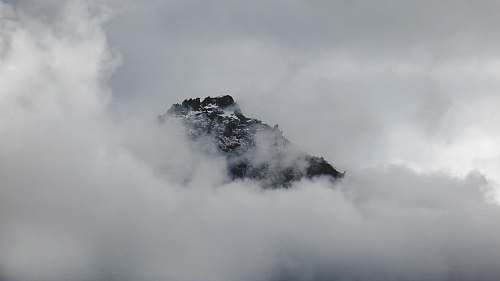 clouds Snowy mountain summer peeks through clouds in Franz Josef Glacier outdoors