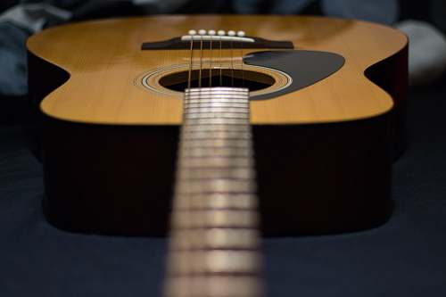 guitar tilt-shift photography of brown acoustic guitar electric guitar