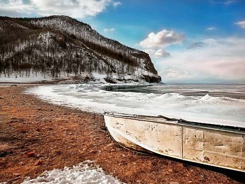 boat beige boat on shore landscape
