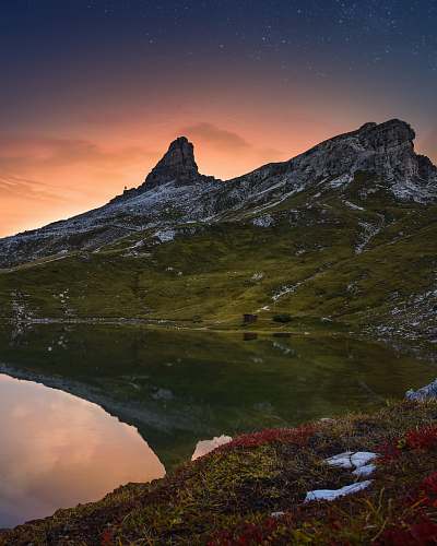 mountain lake surrounded by rock formation mountain range