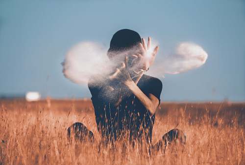 asilah man sitting on brown grass field playing with smoke morocco