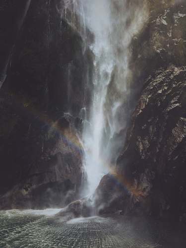 grey rainbow near the waterfalls milford sound