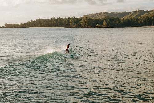 sea woman surfing during daytime wave