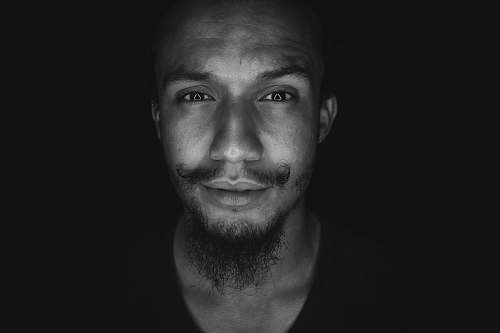 human grayscale photo of man in shirt black-and-white