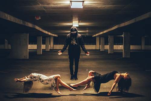 people man standing between two women lying human