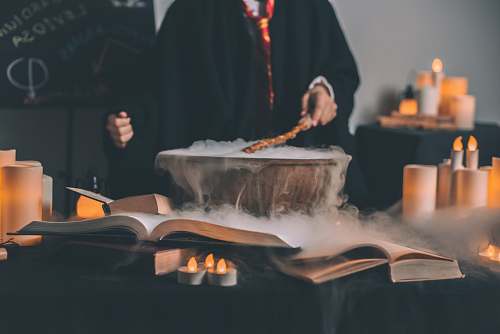 human person holding wand on top of bowl magic