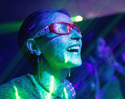 human woman wearing red framed eyeglasses while smiling light