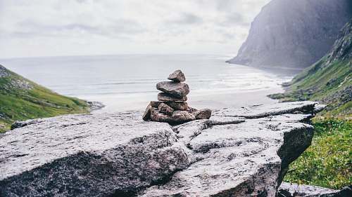 grey cairn stones on rock formation norway