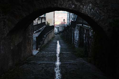sidewalk empty walkway under arch pavement