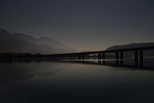 grey calm body of water and dock waterfront
