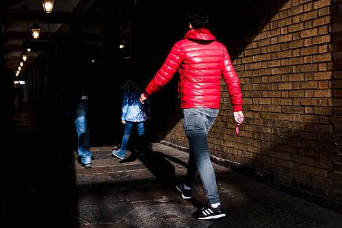 clothing man walking beside wall pants
