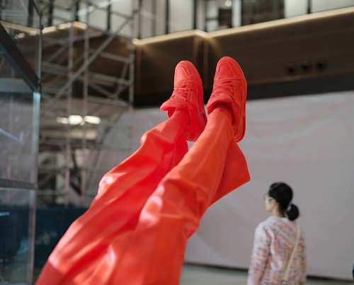 clothing person wearing pair of red sneakers human