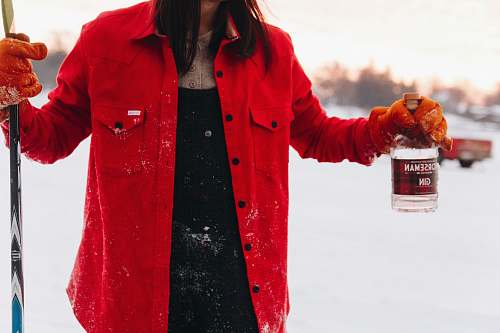 clothing woman in red jacket holding gin bottle coat