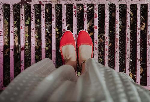 clothing woman standing on pink grill wearing red flats furniture