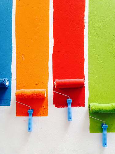 paint four orange, green, blue, and red paint rollers color