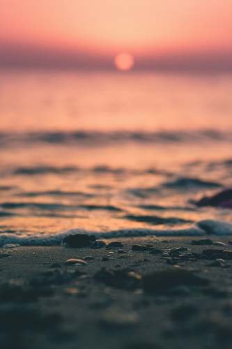 water foreground photography of sand near shore ocean