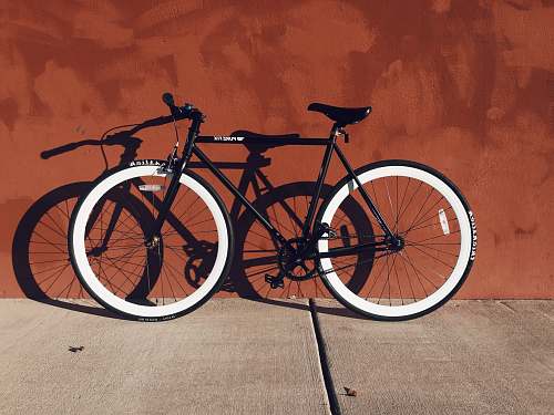 bike black and white mountain bicycle near brown wall red wall