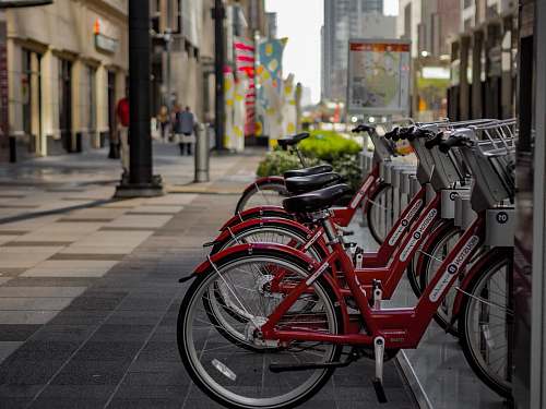 bike parked red bike near road transportation