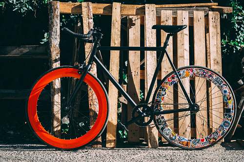 bicycle black and red road bike near wooden crate transportation