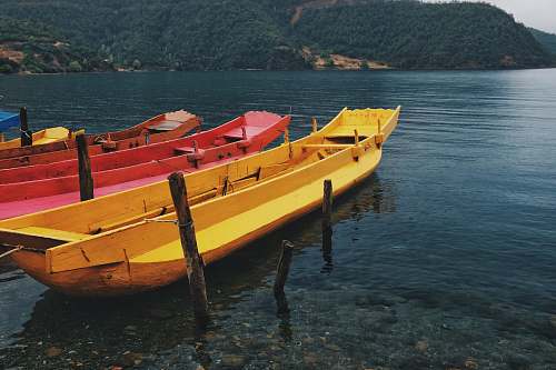 transportation boats near seashore during daytime vessel
