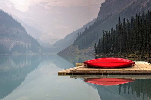 canoe brown floater with red canoe in body of water lake louise