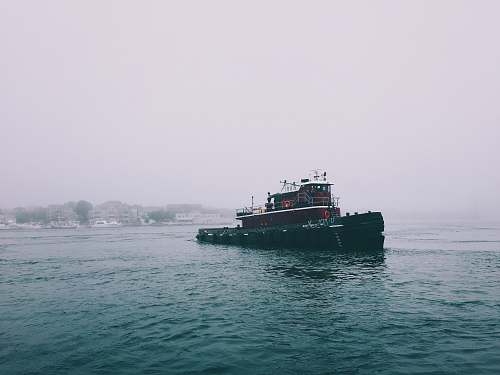 tugboat red and black boat on sea water ship