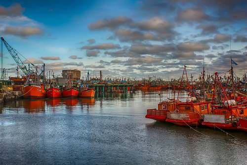 transportation red boat on body of water vessel
