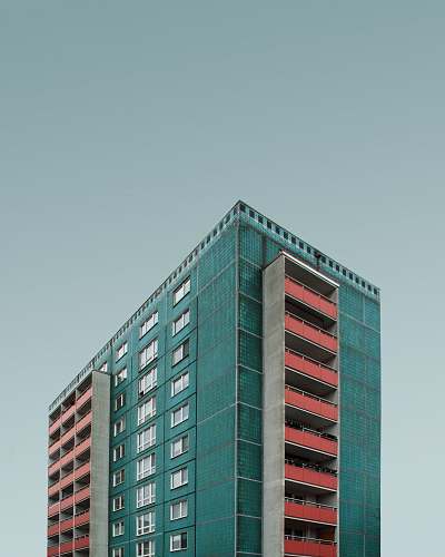 urban blue and white building under dark clouds city