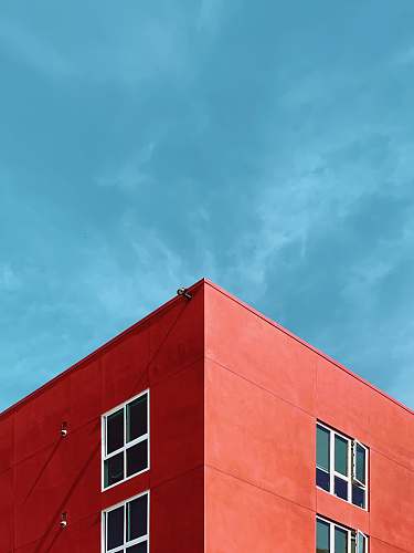 architecture photo of rooftop of red building sky
