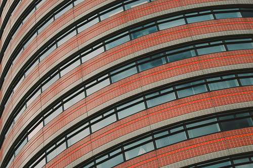 city red and clear concrete glass building low angle photography urban