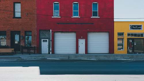 brick white garage doors closed during daytime city