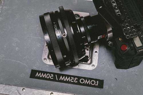 lens black Lomo DSLR camera on gray floor surface vintage glass