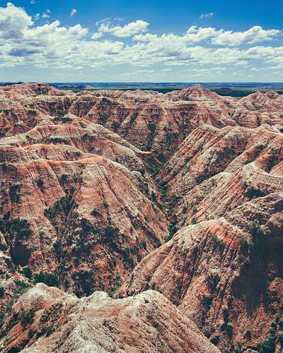 mountain aerial photography of brown rock formation valley