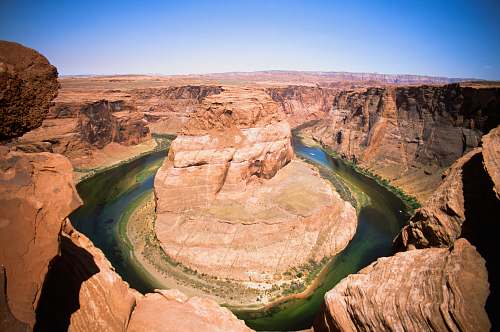 nature rock formation surrounded of body of water mountain
