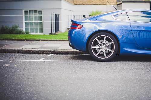 vehicle blue coupe parked in front of house sports car