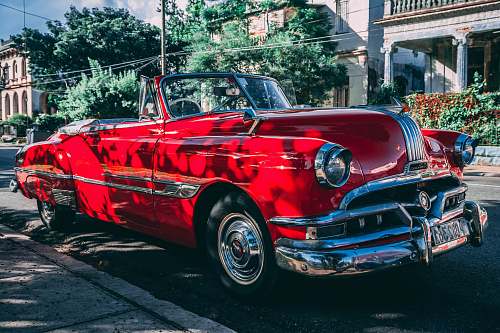 cuba classic red convertible coupe parked beside road havana