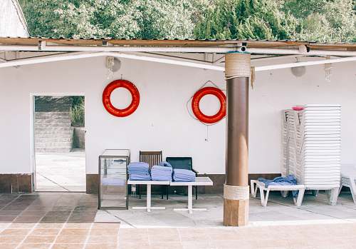 furniture two red inflatable buoys hanging on white wall gutter