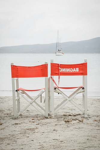 yacht two white folding chairs during daytime at beach boat