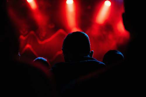 indoors silhouette of a man in front of red lights interior design