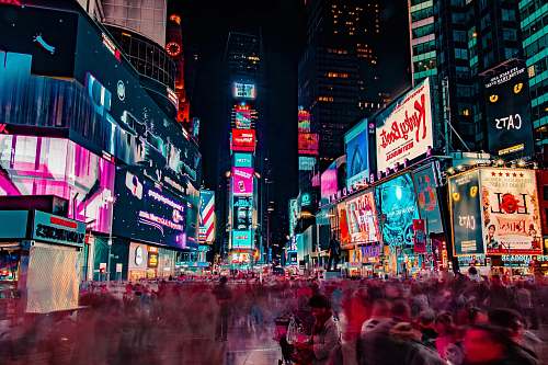 building time-lapse photography of crowd of people on New York Time square during night time night