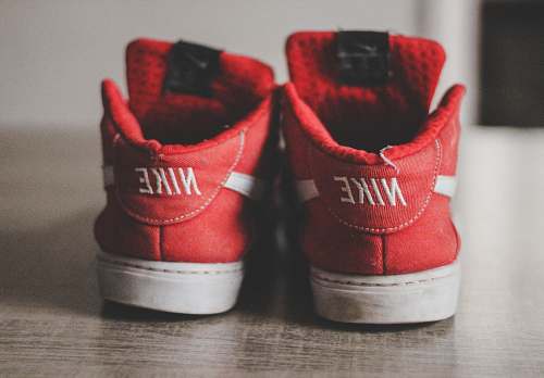 footwear closeup photography of pair of red-and-white Nike low-top shoes brasília