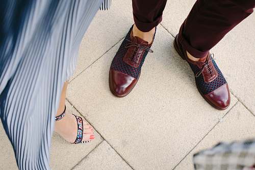 shoe woman standing near man on beige tiled floor footwear