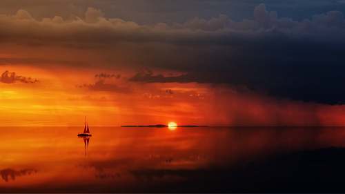 sky silhouette of sailboat on body of water sunrise