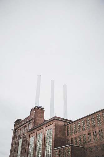 building brown factory under clear sky factory