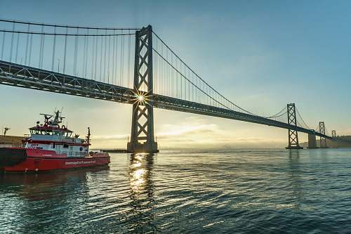 boat ship sailing under bridge san francisco