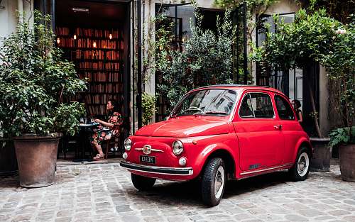vase red 3-door hatchback parked outside establishment pottery