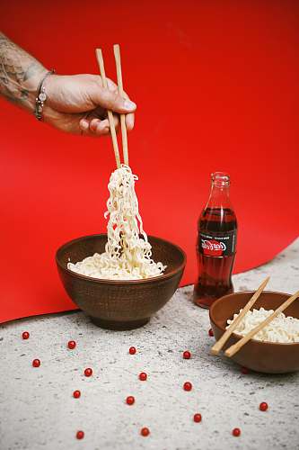 coke bowl of noodle near soda bottle coca